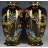 A pair of Chinese cloisonne enamelled, shouldered ovoid vases, decorated with dragons pursuing the
