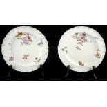A pair of 18th century Chelsea red anchor period silver shaped plates, painted with floral sprigs,