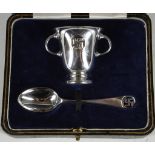 A hallmarked silver christening set by Wakeley & Wheeler London 1923/24, twin handled cup and