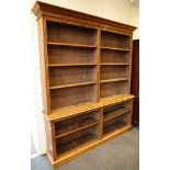 A late Victorian / Edwardian oak two tiered floor standing open bookcase, raised on plinth, 190 x