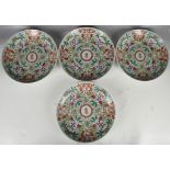 A set of 4 Chinese Famille rose decorated plates with scrolling floral decoration, mid to late