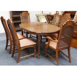 An American walnut dining table and chairs, shaped table on turned legs, 183cm, six chairs (4 +