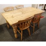 A solid pine kitchen table and four spindle back chairs, 152cm long