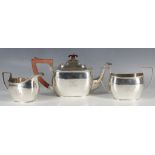A mid 20th century silver three piece tea set, gadroon rim, 'R' monogram, Birmingham 1945, 726grs