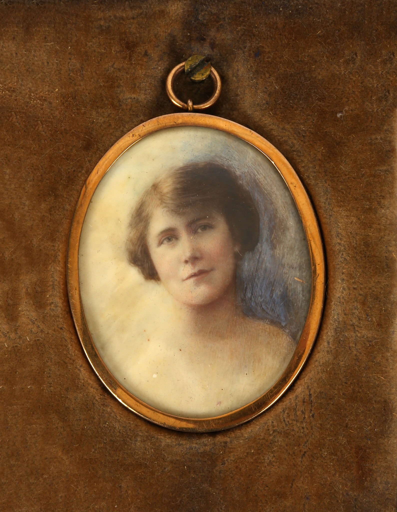 A late 19th century portrait miniature of a bare-shouldered young woman. In a rose gold oval