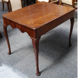 An antique mahogany George I style rectangular table on shaped apron with shell carved frieze drawer
