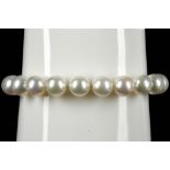 A cultured pearl single strand bracelet, with 18ct gold and diamond set lattice barrel clasp