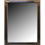 A large decorative hall mirror having scrolling gilded border, 91 x 116cm