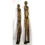 A pair of circa 20th century carved standing African female figures (A.F.). 200cm height, and