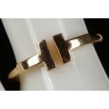 A Tiffany & Co., 18ct gold ring with contemporary design incorporating T's