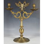 A brass, two branch candlestick with crowned double headed eagle finial, 41cm high