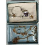 A small selection of jewellery comprising gold chains, a bracelet, a three stone ring, locket, a
