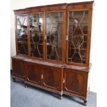 A good Georgian break front astrigal glazed bookcase on a base with cupboards, and raised on a squat