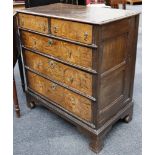 An antique oak chest of two short over long graduated drawers on bracket feet, the blond oak