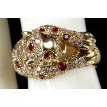 In the manner of Cartier, an 18ct gold, diamond and ruby set panther dress ring dia: 0.99ct, ruby: