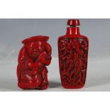 Two Chinese red snuff bottles; an old man holding his catch of fish, 6cm high, and another with
