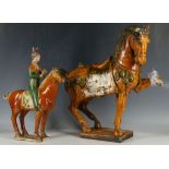 A Chinese pottery tang type horse after Ming Dynasty covered with orange and green lustre glazes,