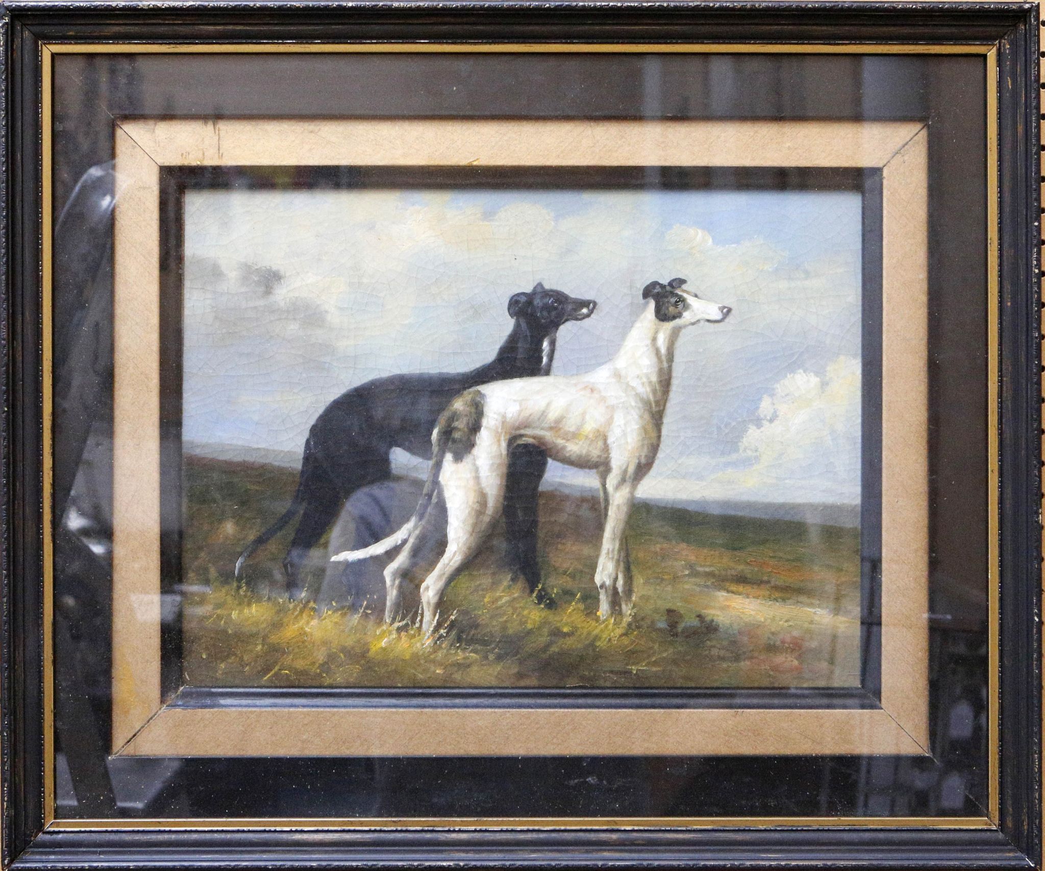 After Maud Earl, oil on canvas, a study of two greyhounds in a landscape, in gilt and ebonised