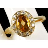 A gold citrine and clear stone cluster ring (unmar