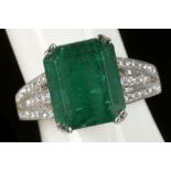 An 18ct white gold, emerald and diamond shouldered