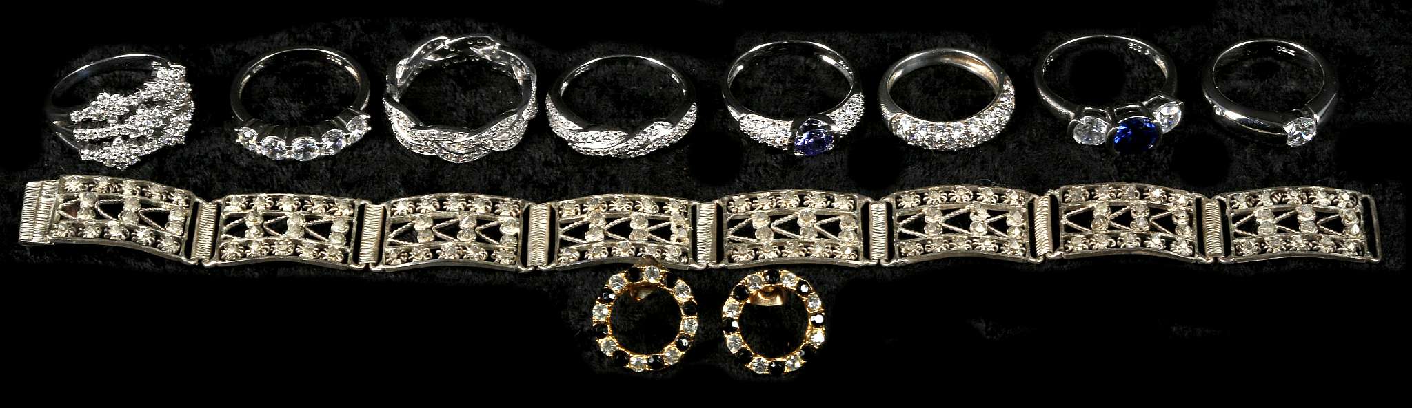 A collection of 8 .925 silver rings set with cubic