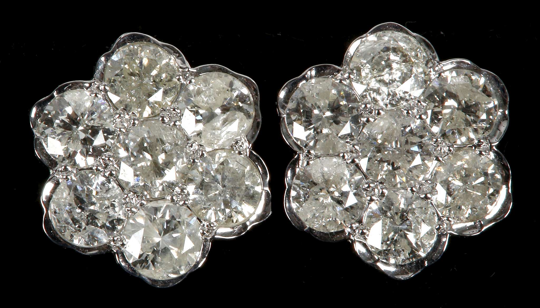 A pair of 18ct white gold and diamond floral clust