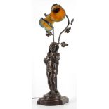 An Art Nouveau style figural lamp, with bronzed figure, coloured glass floral shade with foliate