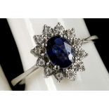 An 18ct white gold, sapphire and diamond cluster r
