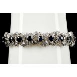 A 14k white gold, sapphire and diamond articulated