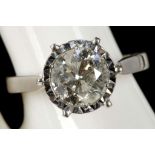An 18ct white gold and diamond solitaire ring, the