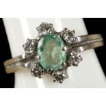 An 18ct gold, emerald and diamond cluster ring