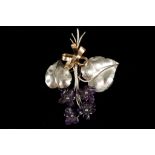 A 14k white gold floral brooch, with work amethyst