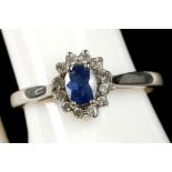 A 14k white gold, sapphire and diamond cluster rin