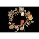 A 9ct gold charm bracelet, with multiple gold and