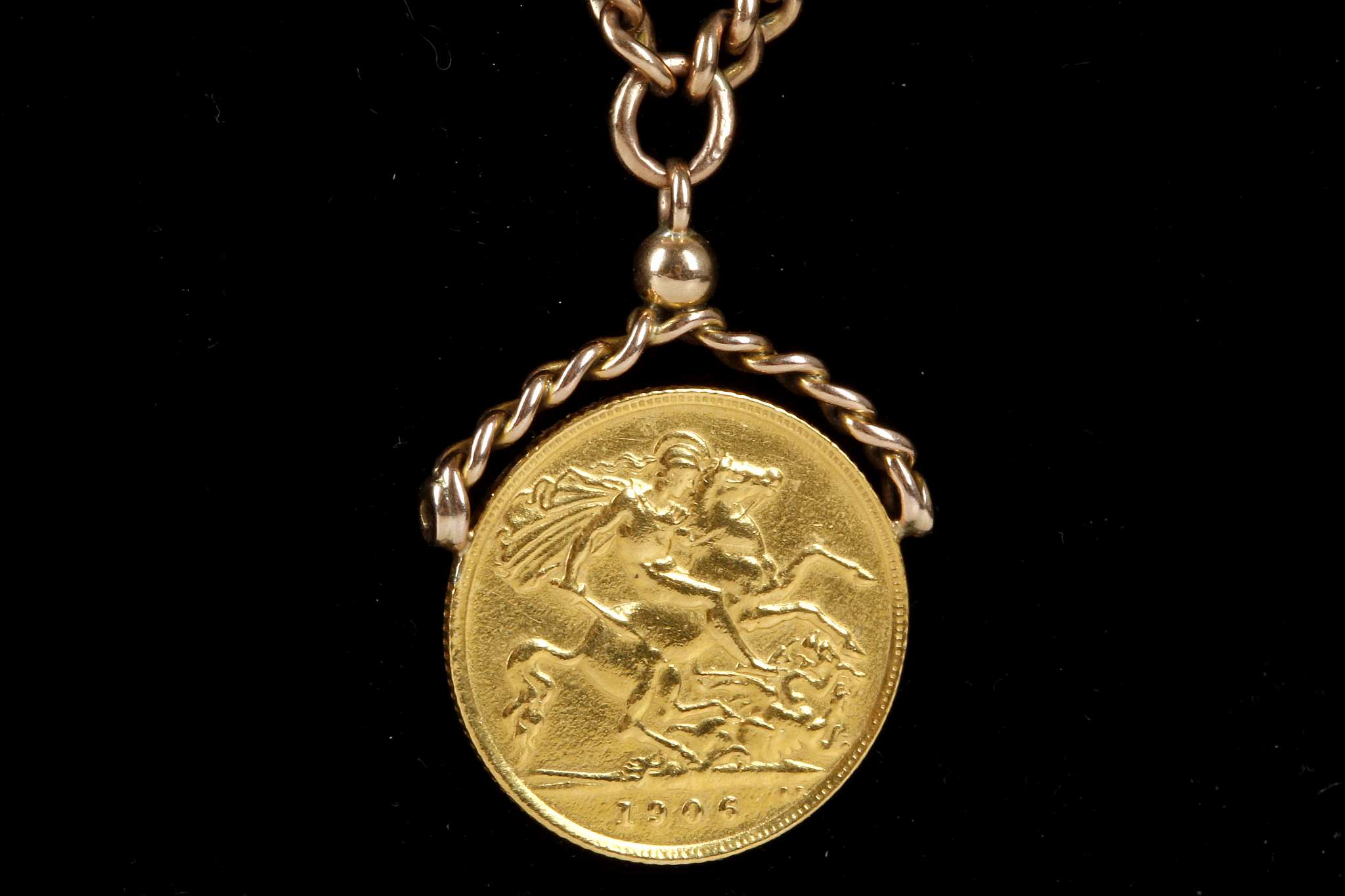 An Edwardian gold half sovereign coin, mounted to