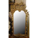 A 19th century style Florentine mirror, carved and