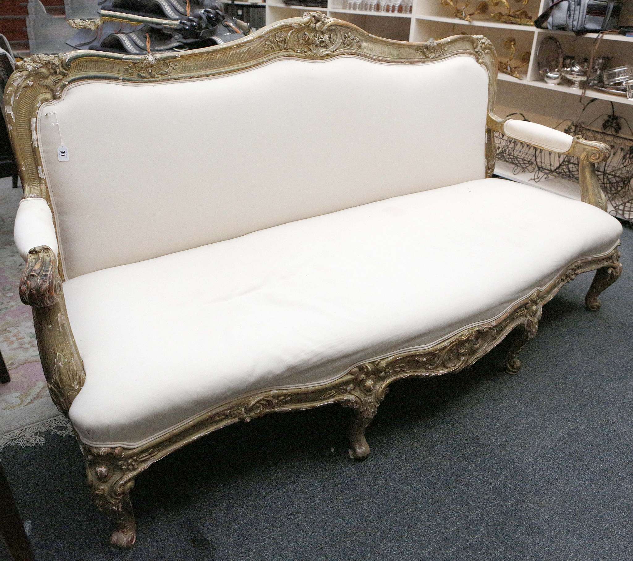 A French 19th century four seat sofa, carved flora