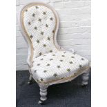 A shabby chic limed spoonback chair, contemporary gilt star upholstery
