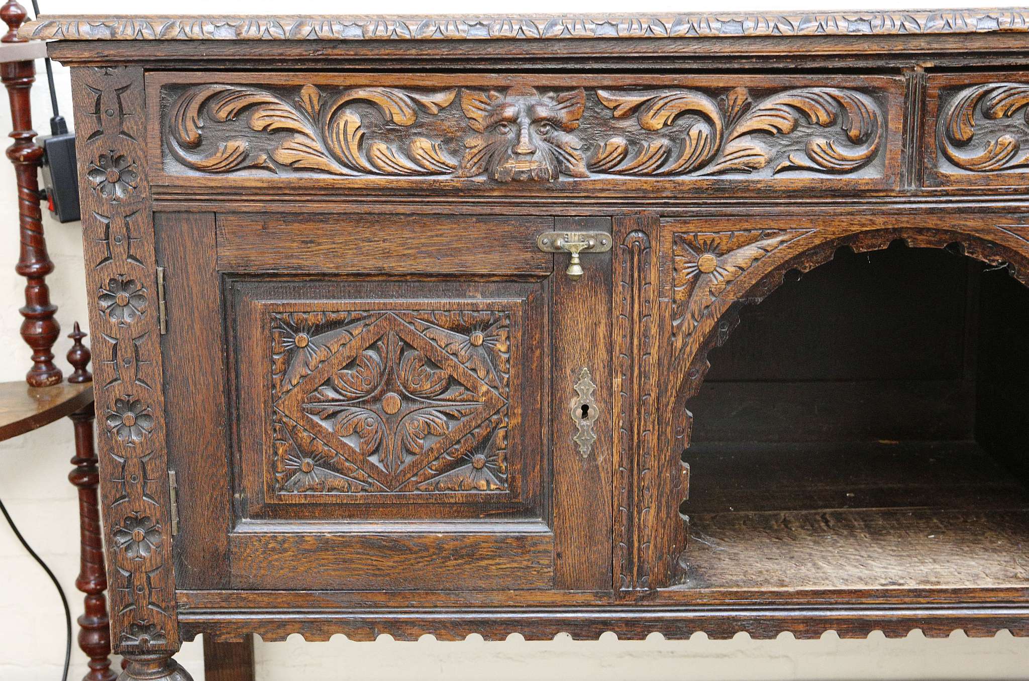 A late Victorian gothic oak sideboard, foliate carving to edge, man of forests masks to two drawers, - Image 2 of 3