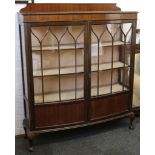 An early 20th century cabinet, mahogany, bow front, double doors, astragal glaze, ball and claw