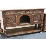 A late Victorian gothic oak sideboard, foliate carving to edge, man of forests masks to two drawers,