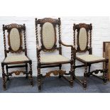 A set of 11 Carolean style oak dining chairs, crown surmount, barley twists flanking upholstered