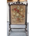 A Victorian mahogany free standing fire screen with floral tapestry panel, pierced and carved top,