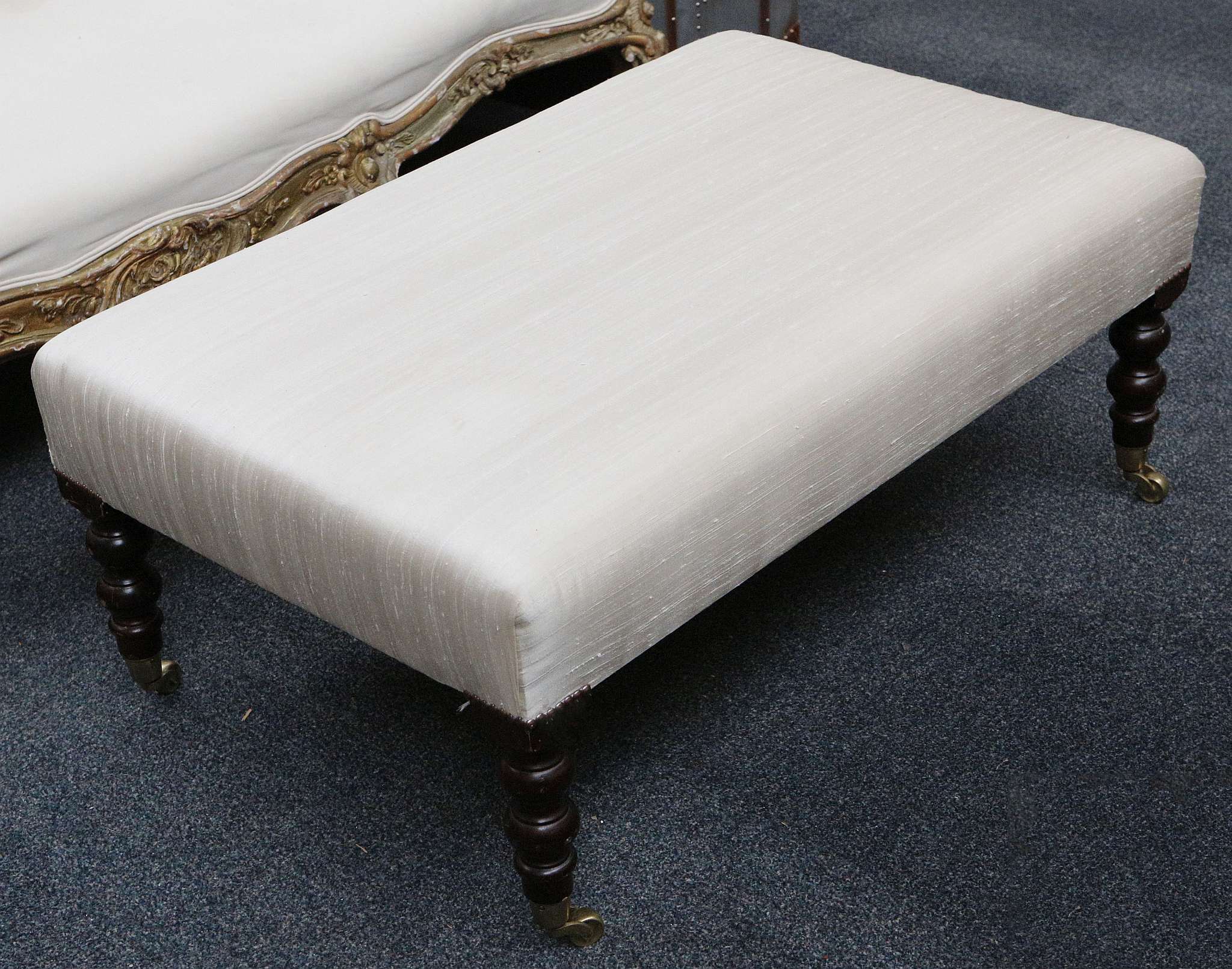 A contemporary lounge stool, cream silk seat, turn