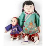 Two Chinese dolls with painted faces, and embroide