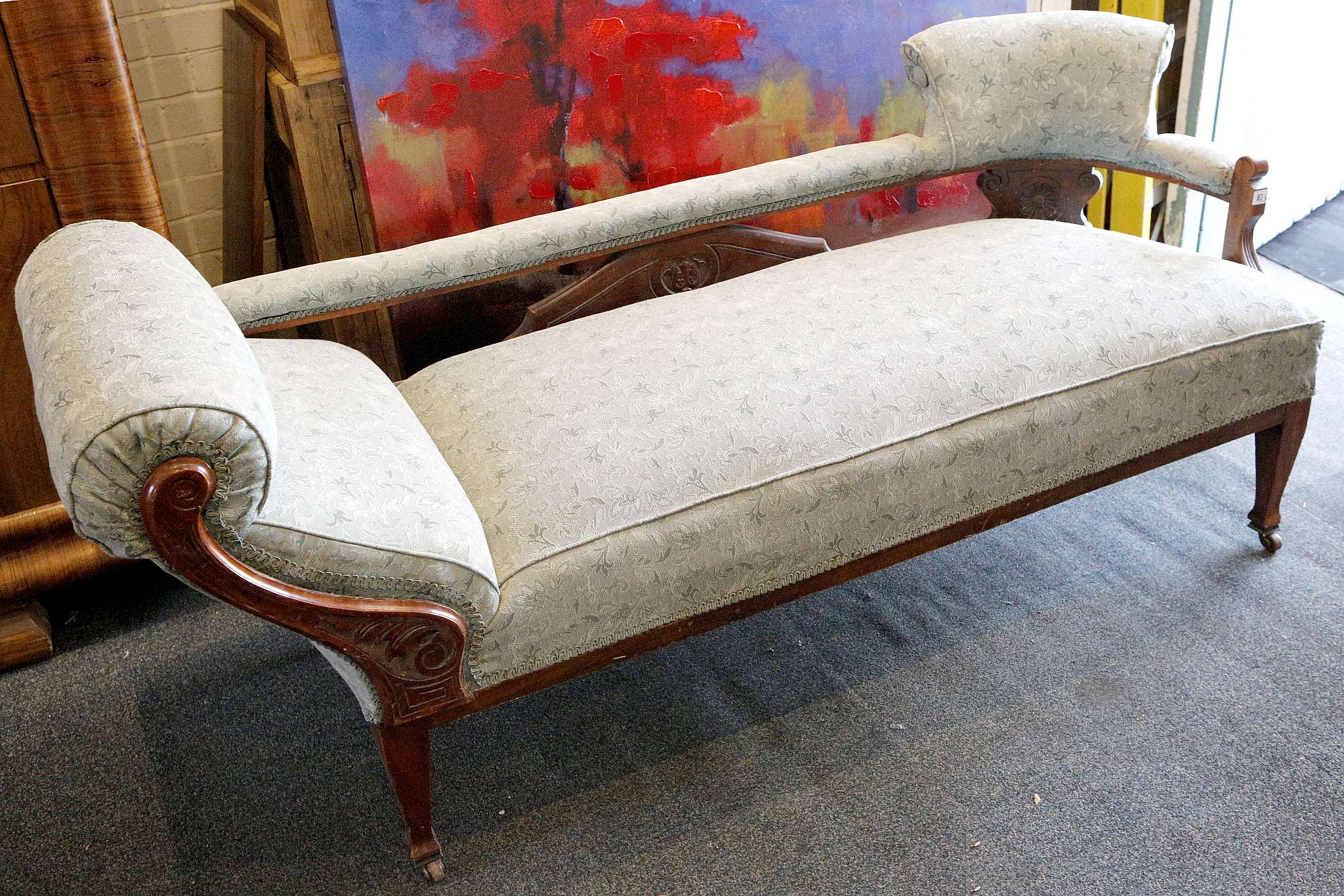 A late Victorian mahogany framed chaise lounge and two matching armchairs