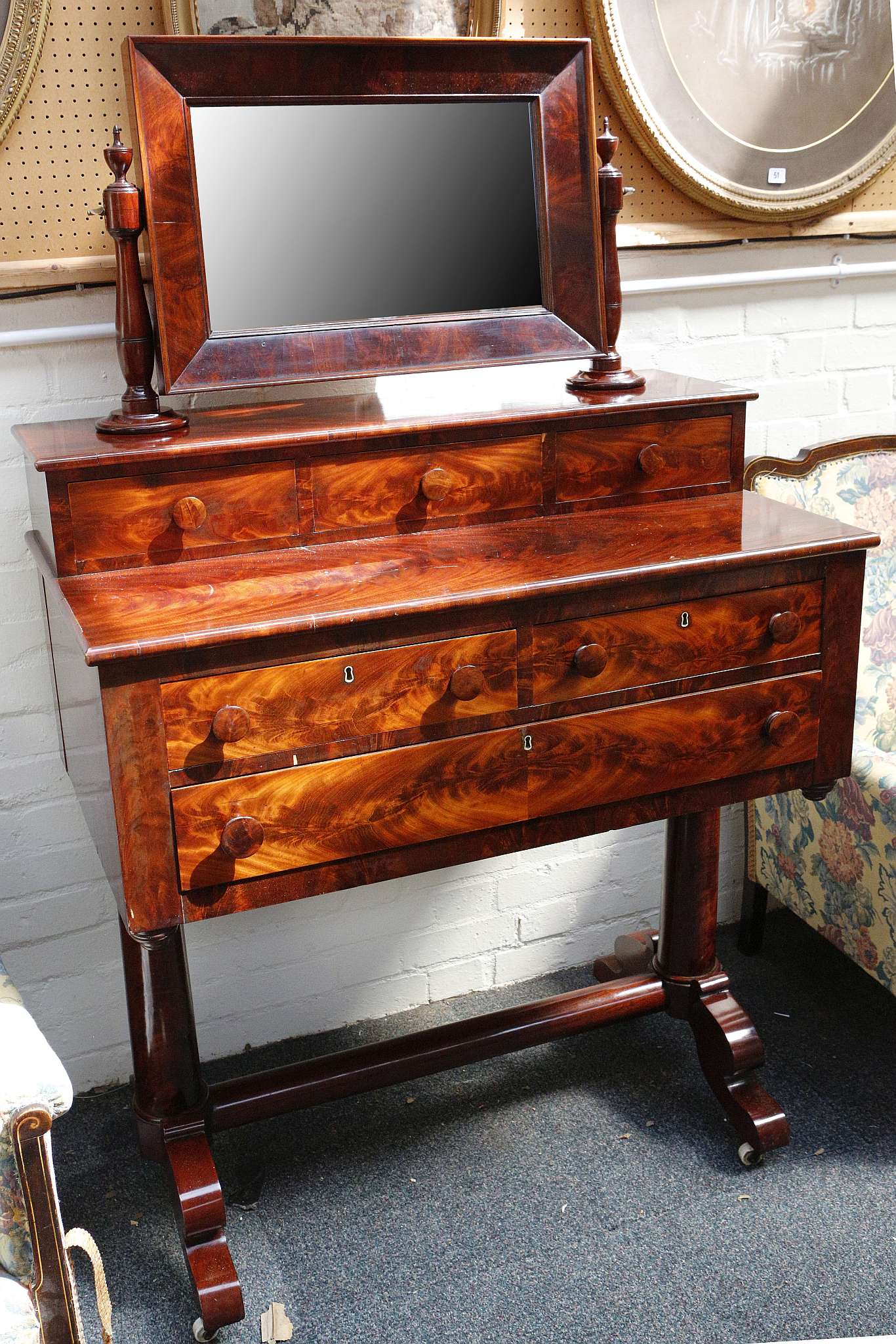 A 19th century French mahogany dressing chest, with articulated mirror over three drawers on