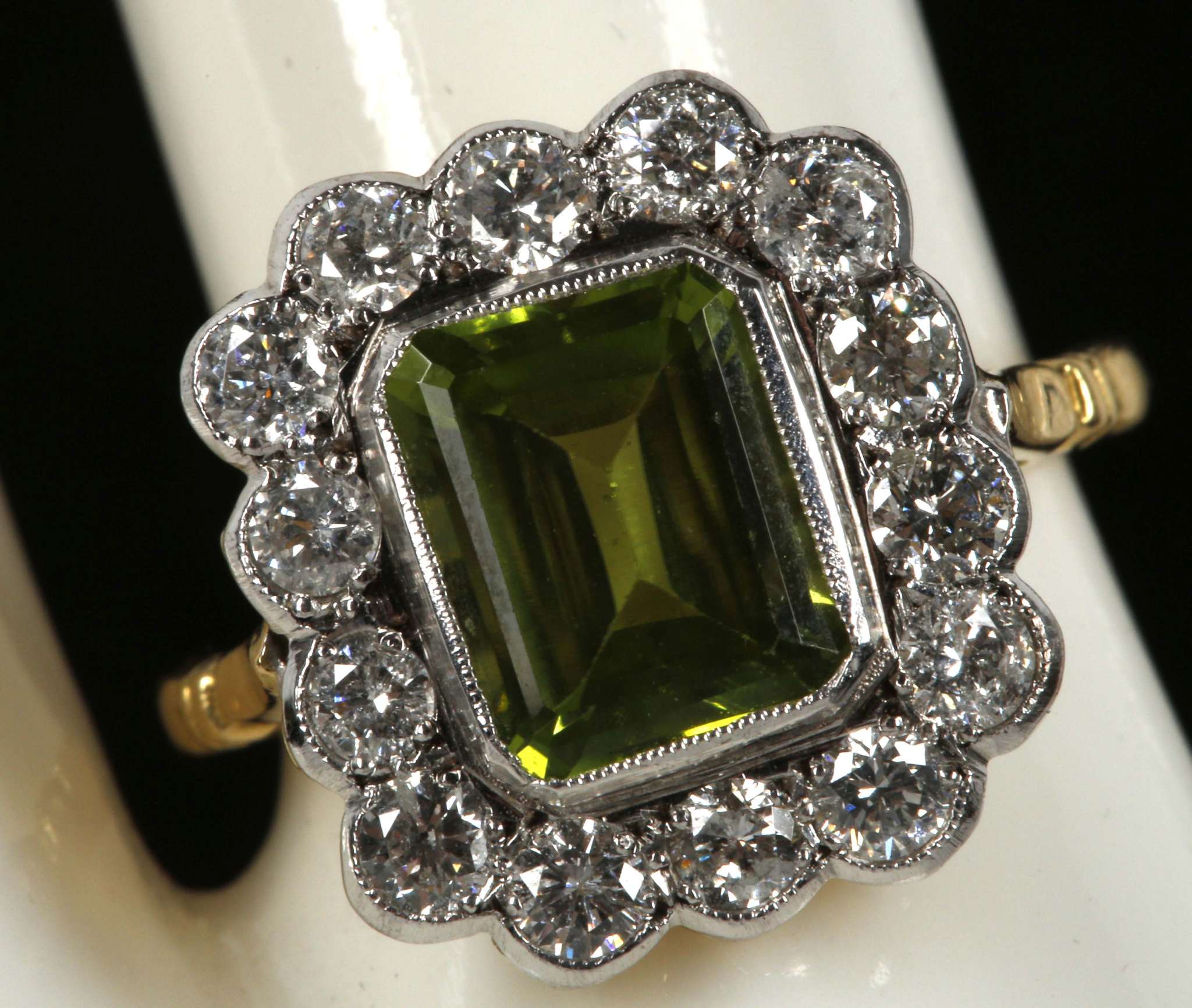 A peridot and diamond cluster ring in 18ct gold