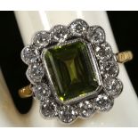 A peridot and diamond cluster ring in 18ct gold