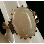 A 14k yellow gold, cabouchon opal and diamond set dress ring
